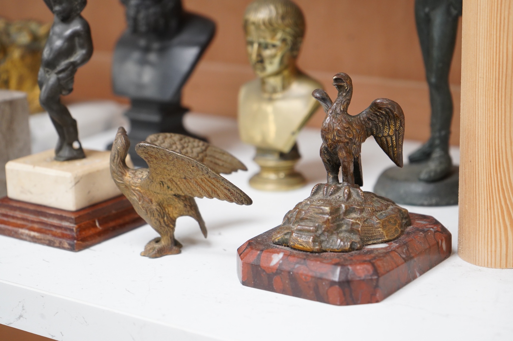 Italian grand tour souvenirs, 19th/20th century; nine small sculptures and busts, after the antique, the majority bronze and one depicting Lucius Verus, largest 19cm high